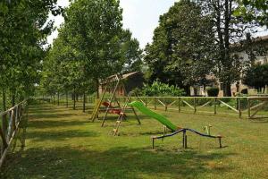 a playground with a green slide in a park at Agriturismo Fiamberta in Certosa di Pavia