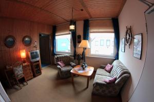 a living room with a couch and chairs and a table at Hotel Restaurant Zum Postillion in Soltau