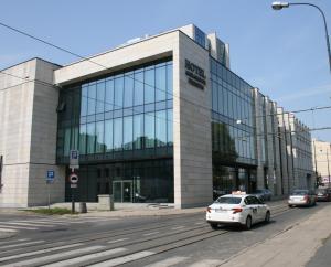 a car is parked in front of a building at Ambasador Premium in Łódź