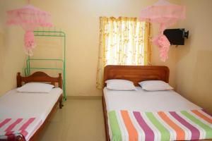 Postel nebo postele na pokoji v ubytování Yaswi Guest House