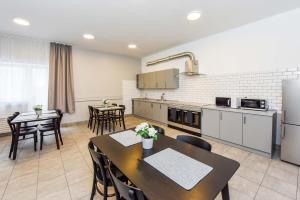 a kitchen and dining room with a table and chairs at KTU Rest House Politechnika in Palanga