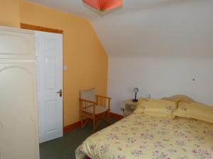 a bedroom with a bed and a desk and a chair at Skellig Cottages in Ballinskelligs
