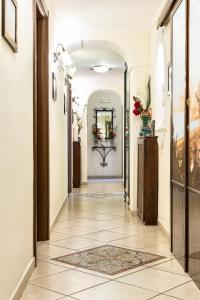 a hallway with a tile floor and an archway at B&B Art Suite Principe Umberto in Naples