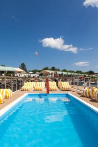 a swimming pool with lounge chairs on a deck at Yachtsman Lodge & Marina in Kennebunkport