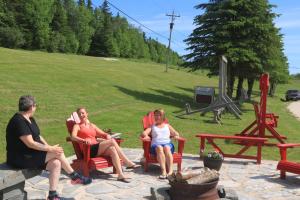 a group of people sitting in chairs on a patio at Rocky Brook Acres in Cormack
