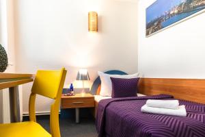 En eller flere senge i et værelse på Hotel Ambiente Berlin City