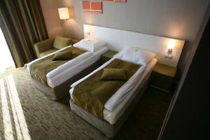 Posteľ alebo postele v izbe v ubytovaní Hotel EMPIRE