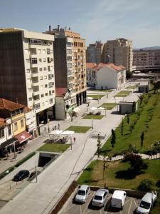 a city with cars parked in a parking lot at Apartamento Alvares Cabral in Vila Nova de Gaia