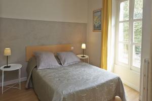 Postel nebo postele na pokoji v ubytování Hôtel Le Foch