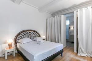 モンペリエにあるVilla jeu de paume - Première conciergerieのベッドルーム1室(白いシーツと白いカーテンのベッド1台付)