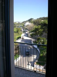 a room with a balcony with a view of a road at Residence Ducale in Rodi Garganico