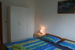 Postel nebo postele na pokoji v ubytování Apartmani Halilovic
