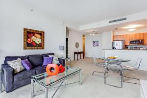 a living room with a couch and a table at Dadeland Towers by Miami Vacations in South Miami