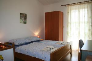 Postel nebo postele na pokoji v ubytování Apartmani Halilovic + 37 fotografií