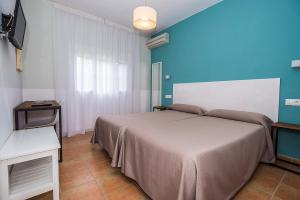 Postel nebo postele na pokoji v ubytování Hostal Las Cumbres
