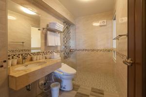 a bathroom with a toilet and a sink and a mirror at Sea Dragonfly in Yanliau +50 photos