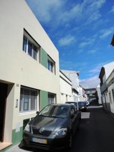 a black car parked in front of a building at Lena's Home in Ponta Delgada