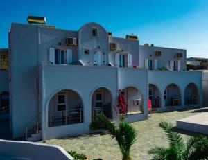 a large white building with a lot of windows at Unique Galini Oia - Adults Only in Oia