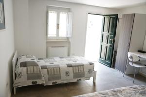 a bedroom with a bed and a sink and a window at Rizzi Residence in Matera