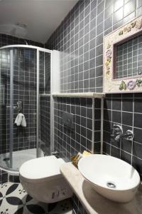 a bathroom with a sink and a toilet and a shower at Kidalyo Hotel - Special Category in Ayvalık