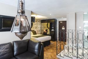 a living room with a couch and a chandelier at Le Monde Hotel in Edinburgh