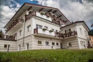 a large white building with balconies on top of it at Appartementhaus Sapelza in Dobbiaco