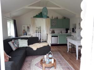 a living room with a couch and a table at Rietzicht in Alkmaar +7 photos