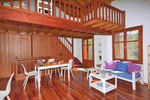 a living room with a blue couch and a table at Cambos Villa in Skopelos Town