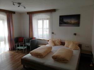 a bedroom with a bed with two pillows on it at Apart Waldegger in Nauders