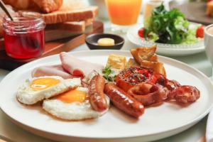a plate of breakfast food on a table at Volve Hotel Bangkok in Bangkok