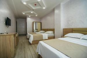 Ένα ή περισσότερα κρεβάτια σε δωμάτιο στο Hotel Batumi Palace