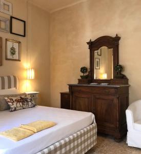 a bedroom with a bed with a dresser and a mirror at La Casa di Zia Rita in Porto SantʼElpidio