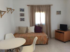 a bedroom with a bed and a table and chairs at Sa Figuera in Sant Francesc Xavier