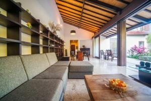 a living room with a couch and a table at Tirta Villa in Sanur