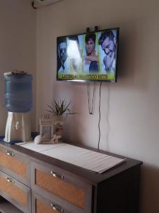 a flat screen tv hanging on a wall at Private Apartments in Caribe Dominicus solo adultos in Bayahibe