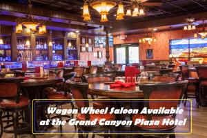 
a restaurant with tables, chairs, and a bar at Canyon Plaza Premier Studio and Apartments in Tusayan
