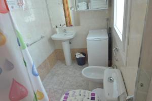 a small bathroom with a toilet and a sink at Armonía Beach 17 in Arinaga