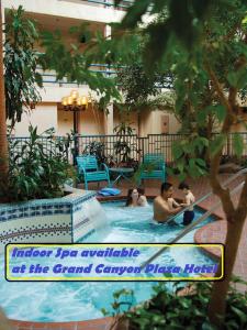a group of people sitting in a swimming pool at Canyon Plaza Premier Studio and Apartments in Tusayan