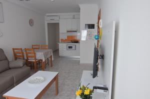 a kitchen and living room with a couch and a table at Armonía Beach 17 in Arinaga