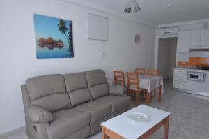 a living room with a couch and a table at Armonía Beach 17 in Arinaga