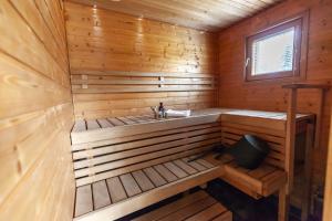 a wooden sauna with a sink and a window at Terra Ultima in Rovaniemi +46 photos