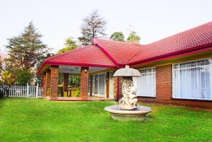 a house with a fountain in front of a house at Fuhri Road Apartments Madison House in Alberton