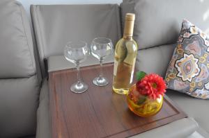a bottle of wine and two wine glasses on a table at Armonía Beach 17 in Arinaga