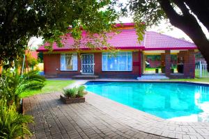 a house with a swimming pool in front of a house at Fuhri Road Apartments Madison House in Alberton