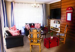 a living room with a couch and a chair at Fuhri Road Apartments Madison House in Alberton