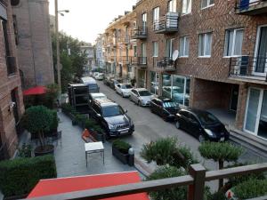 a view of a street with cars parked in a parking lot at Hotel Lions in Tbilisi City