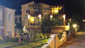 a house with lights on the front of it at night at Edem in Vatera