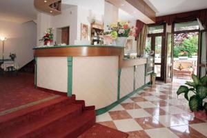 a lobby of a hotel with a counter and stairs at Nice Hotel in Marghera