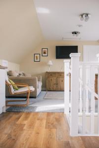 a living room with a couch and a tv at Sea Shimmer in Portree