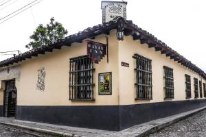 a building with a clock on the front of it at Hotel Museo Mayan Inn in Chichicastenango